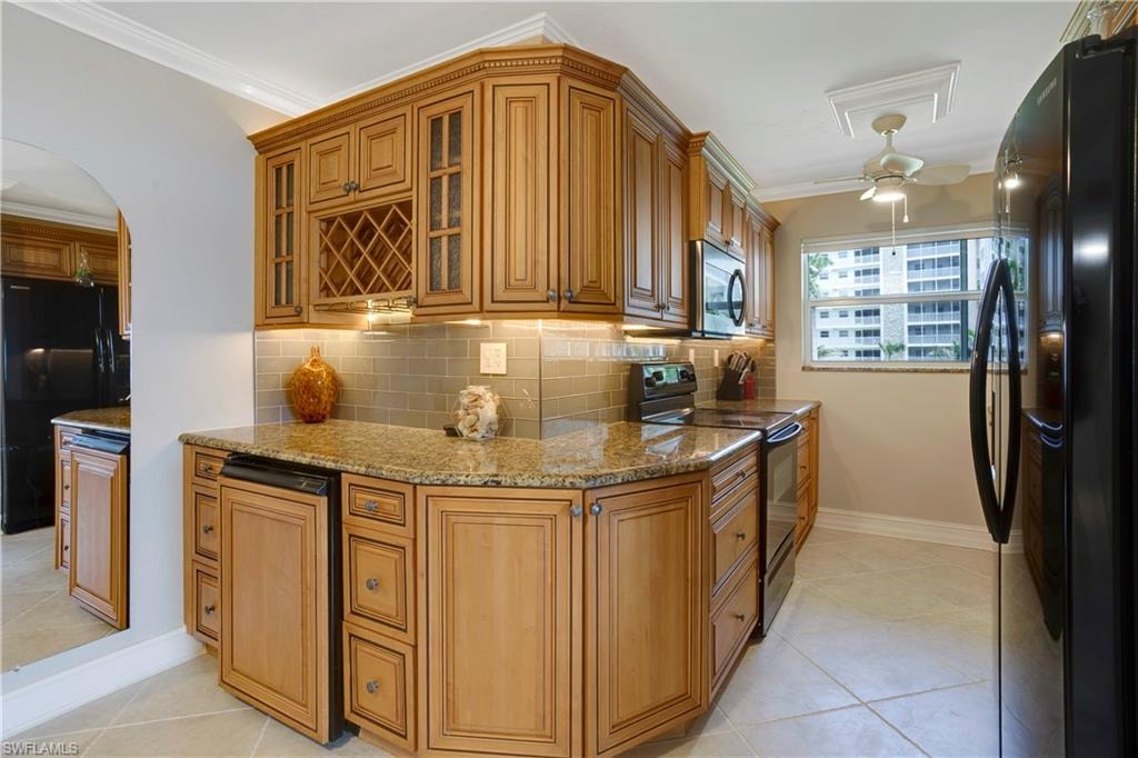Reconfigured kitchen with wine rack, glass cabinet doors, glass subway tile.