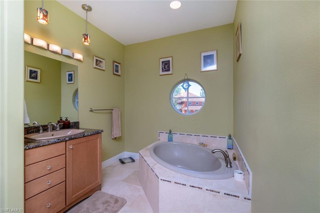 Junior suite bathroom with Travertine flooring & shower, garden tub