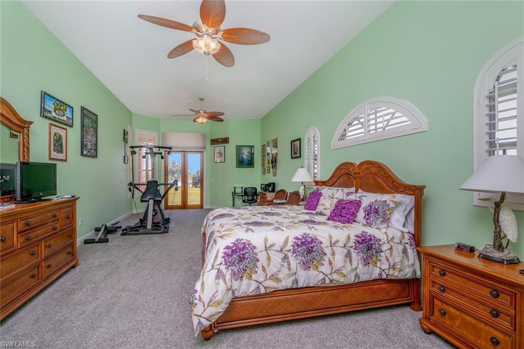 Master Bedroom down with water view and  featuring access to outside, ceiling fans and ensuite bathroom