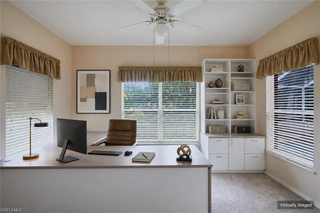 Spare room with light colored carpet, plenty of natural light, a ceiling fan, and baseboards