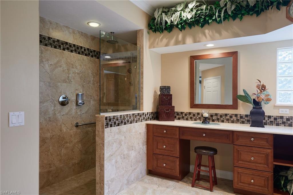 Carpeted empty room with a ceiling fan, baseboards, and lofted ceiling