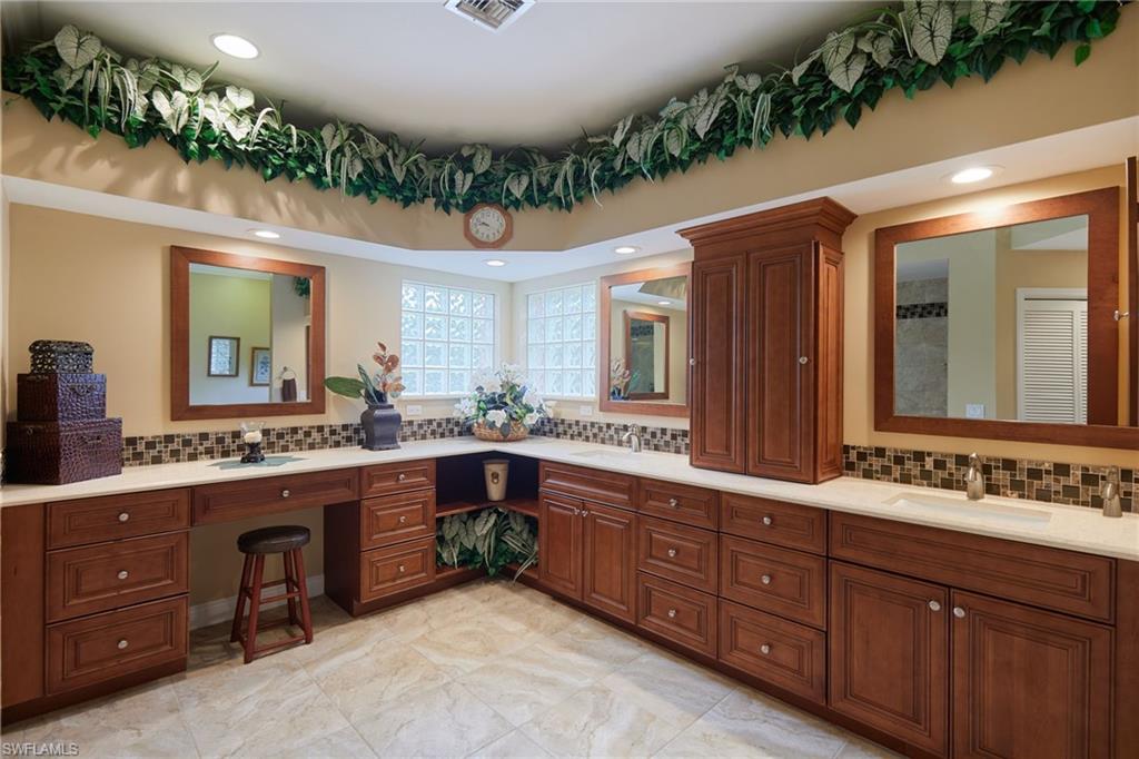 Bathroom with vanity, toilet, a stall shower, and tile patterned flooring
