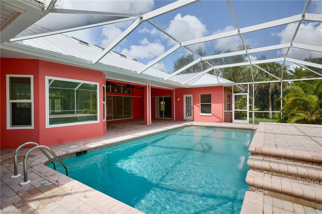 View of front of home with french doors, driveway, and a front yard