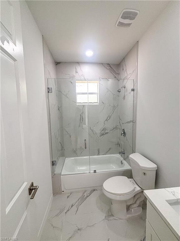 Bathroom with light marble finish floors and vanity