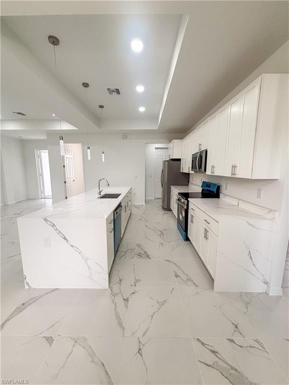 Bathroom featuring light marble finish floors, vanity, a marble finish shower, and a closet