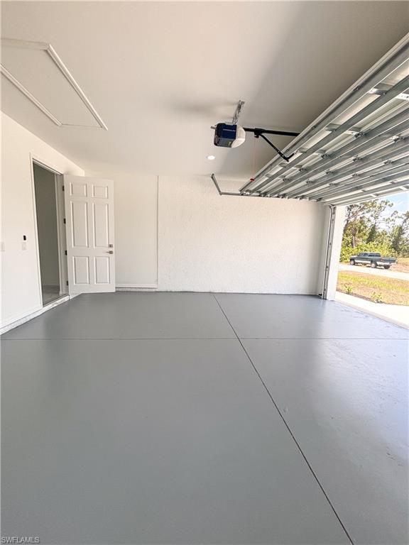 Unfurnished living room with a tray ceiling, light marble finish floors, and recessed lighting
