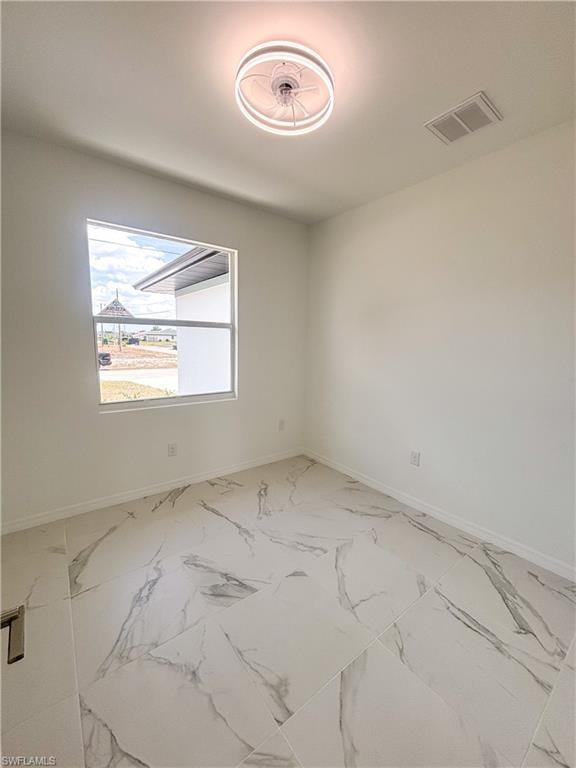 Kitchen with appliances with stainless steel finishes, recessed lighting, white cabinetry, light marble finish flooring, and light stone countertops