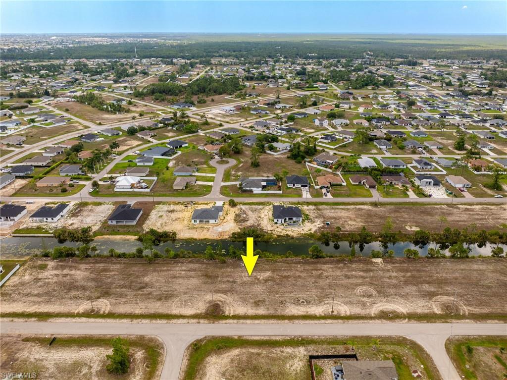 View of property location featuring a large body of water and nearby suburban area