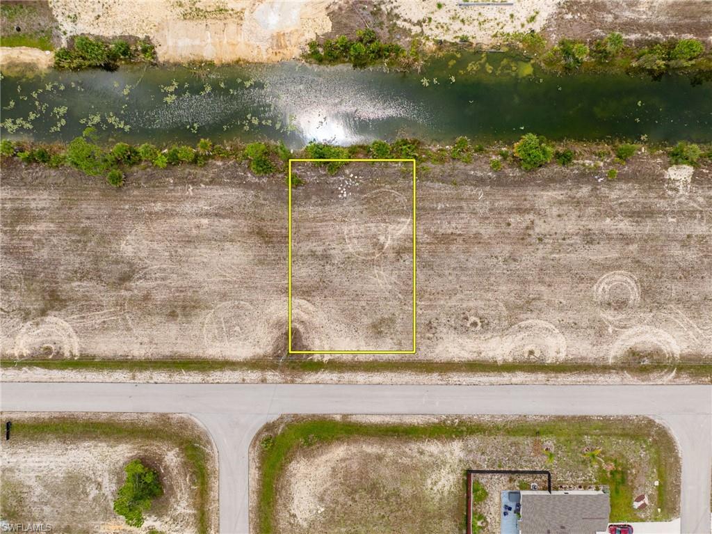 Aerial overview of property's location featuring property parcel outlined and a nearby body of water