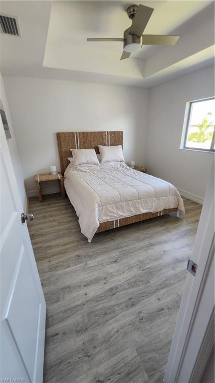 Bedroom featuring wood finished floors, ceiling fan, and baseboards