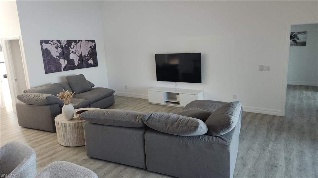 Living area featuring wood finished floors and baseboards