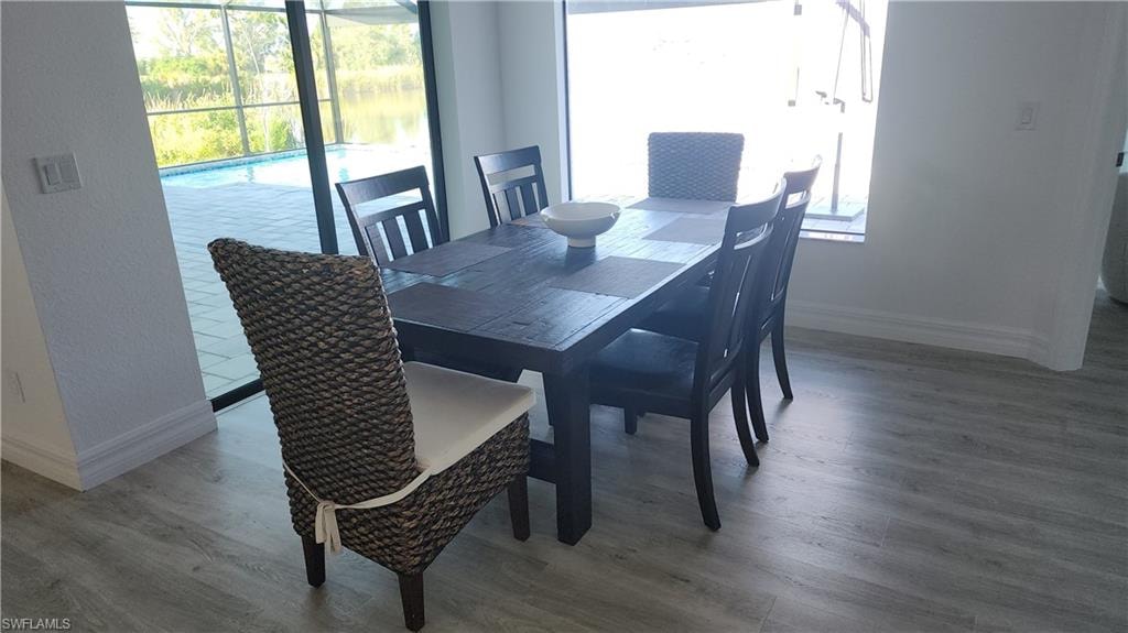 Dining area with wood finished floors and baseboards