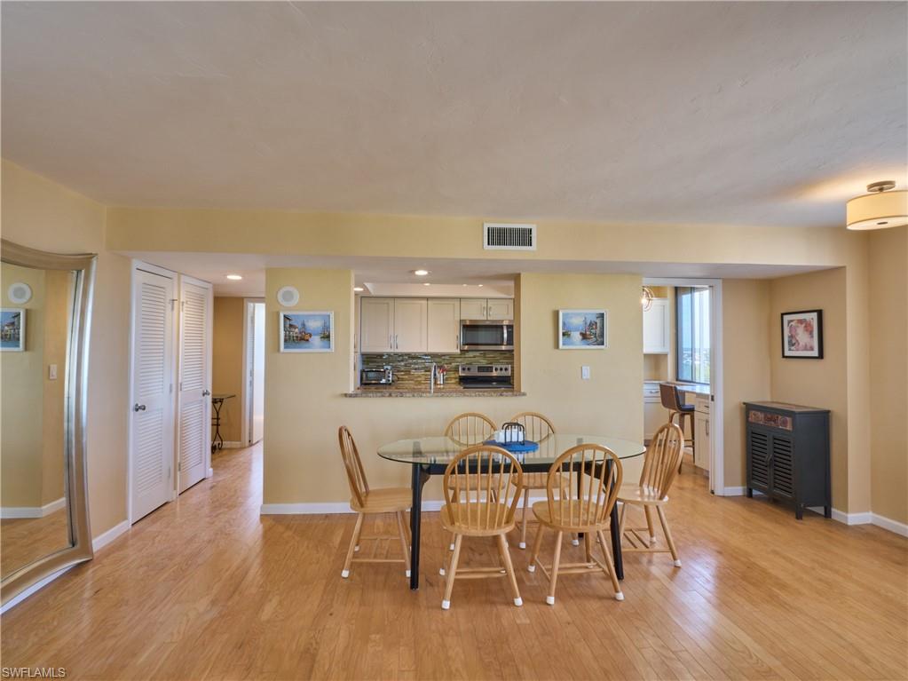 Dining area featuring light wood finished floors, baseboards, and recessed lighting