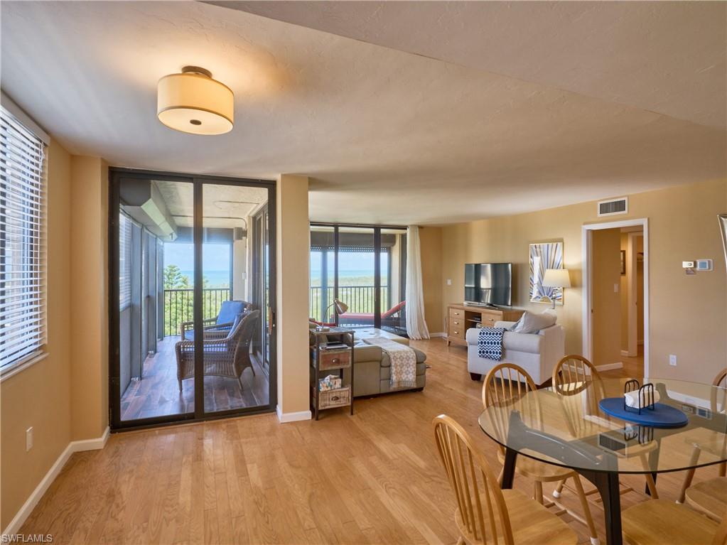 Dining area with light wood finished floors, baseboards, and healthy amount of natural light