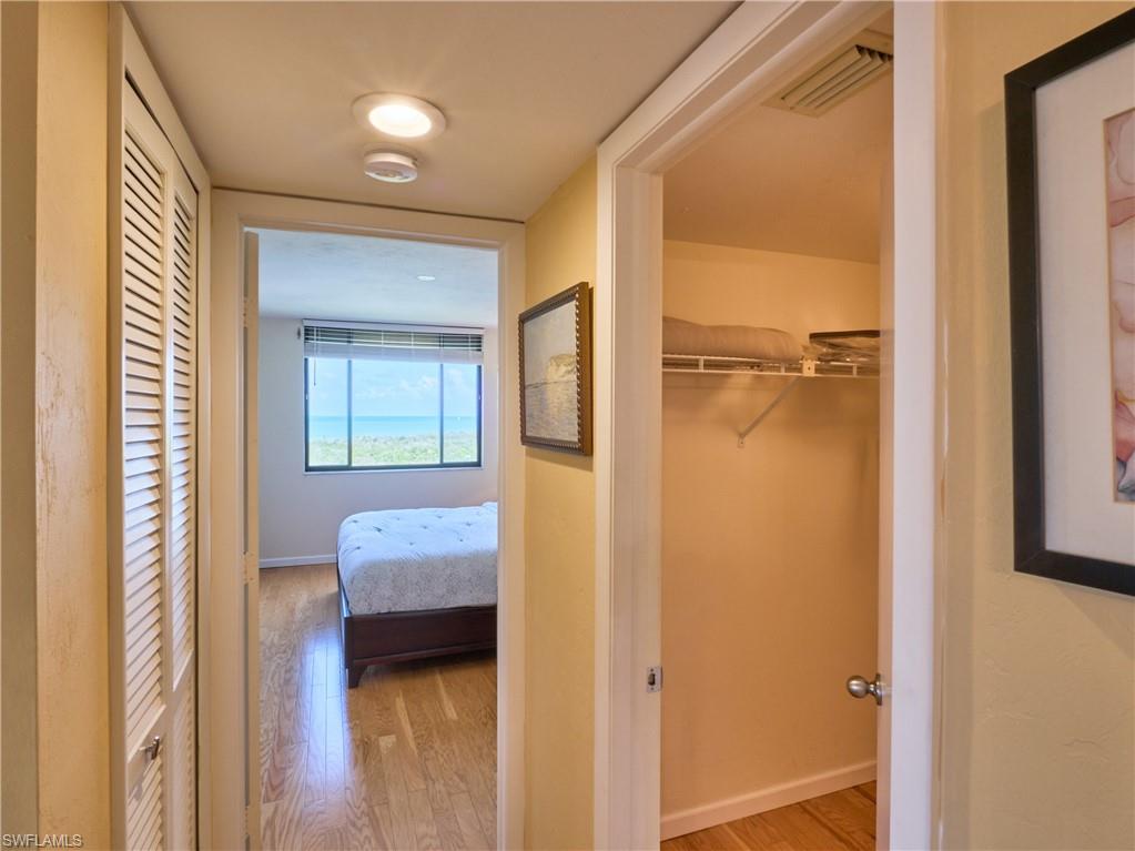 Corridor featuring wood finished floors and baseboards