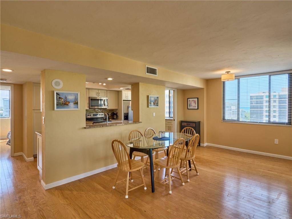 Dining space featuring light wood-style flooring, baseboards, and healthy amount of natural light