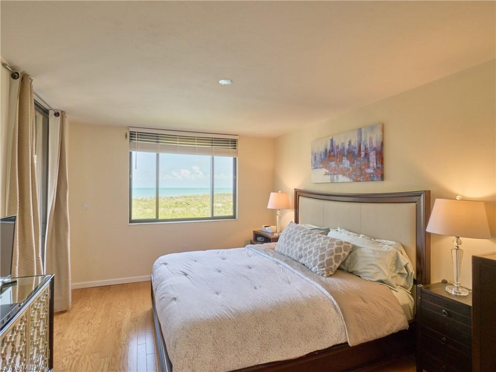 Bedroom with light wood-type flooring, baseboards, and recessed lighting