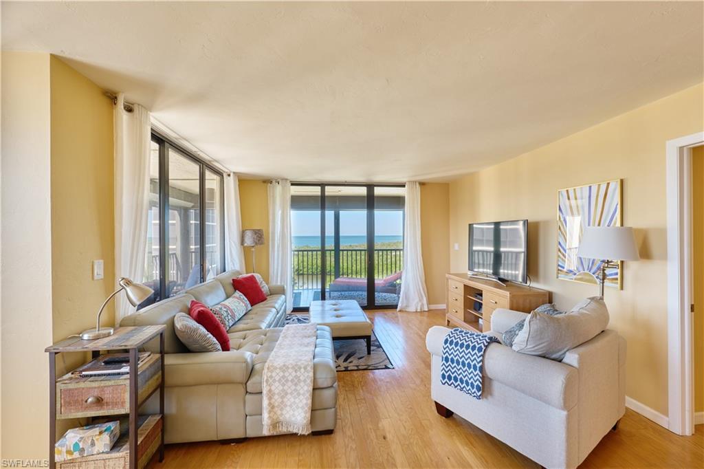 Living area featuring wood finished floors and a wall of windows