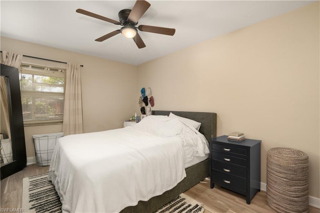 Bedroom featuring light wood-type flooring, baseboards, and ceiling fan