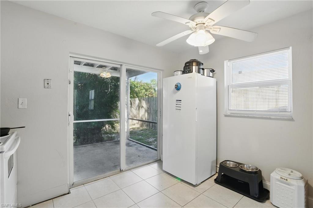 Entryway with light tile patterned floors and ceiling fan