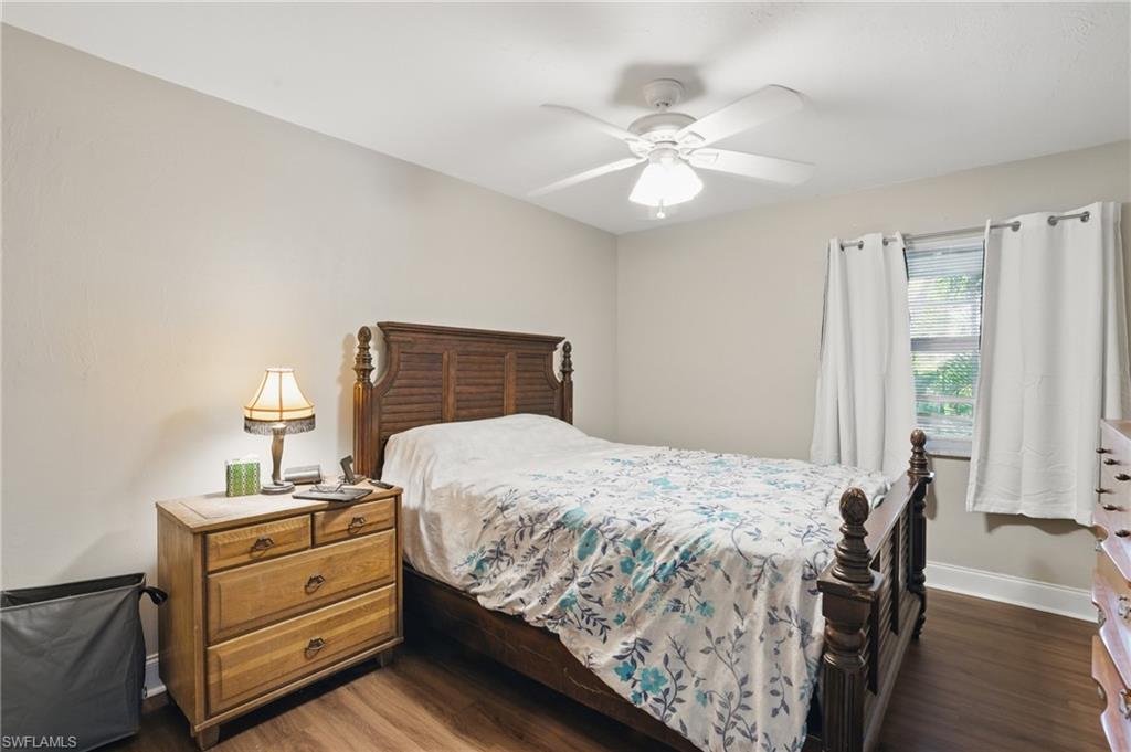 Bedroom with wood finished floors, baseboards, and ceiling fan