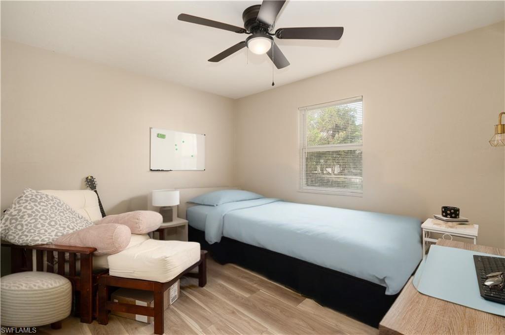 Bedroom with light wood-style flooring and a ceiling fan