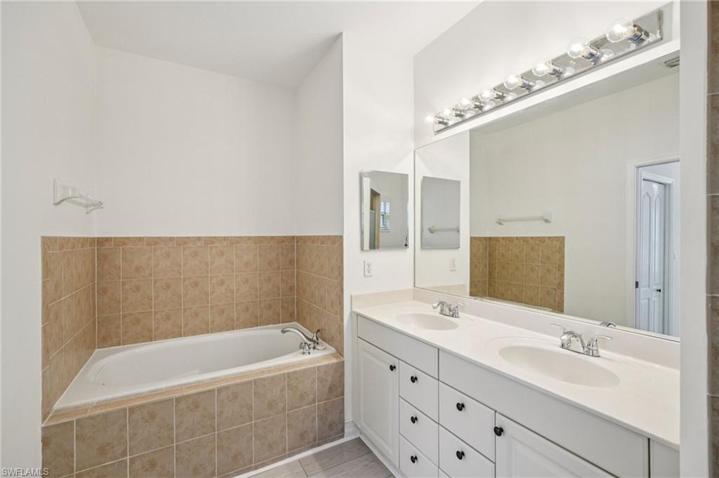 Bathroom featuring double vanity and a garden tub