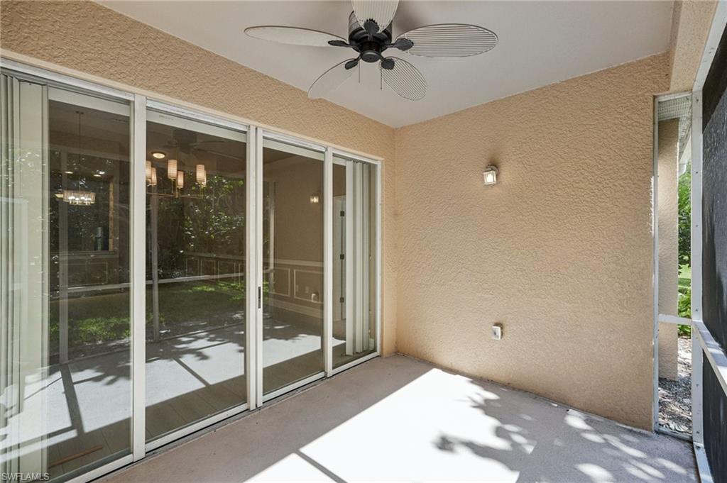 Unfurnished sunroom featuring ceiling fan