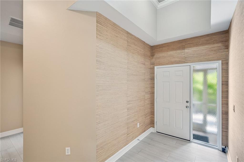 Foyer featuring baseboards and light wood-type flooring