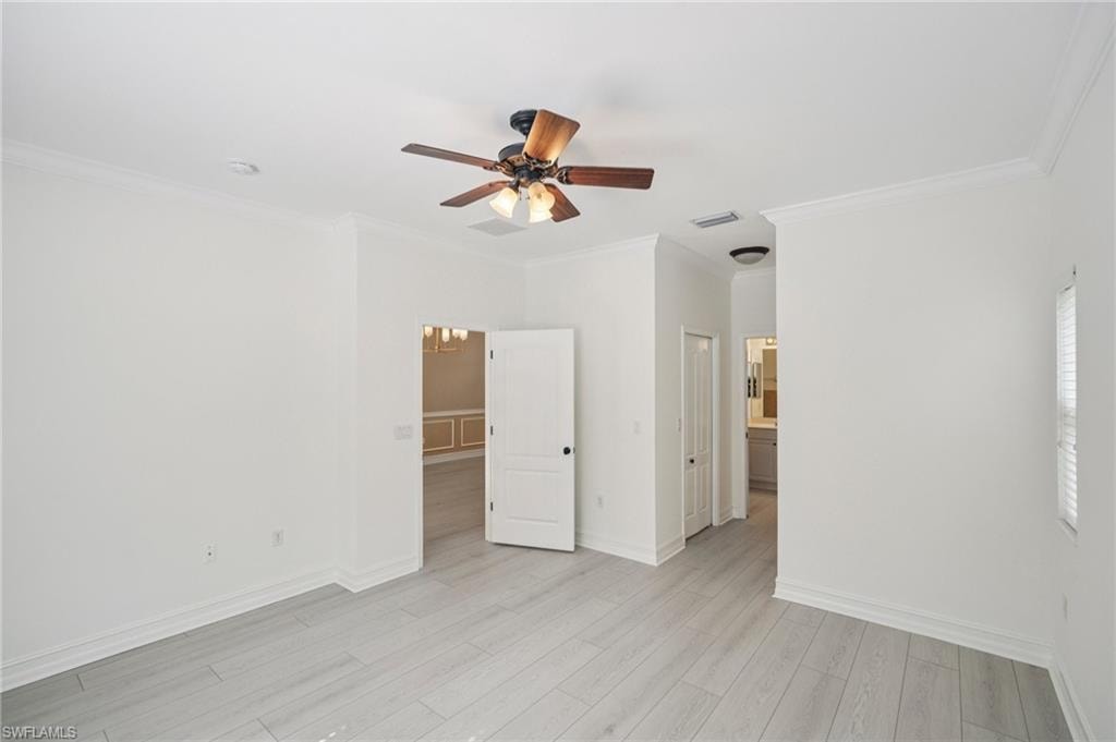 Unfurnished bedroom with crown molding, light wood-type flooring, and a ceiling fan