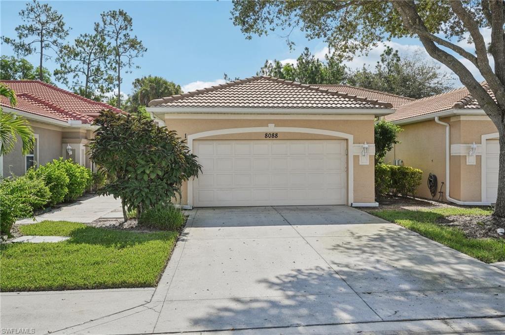Mediterranean / spanish-style home with concrete driveway, stucco siding, a tile roof, and a garage