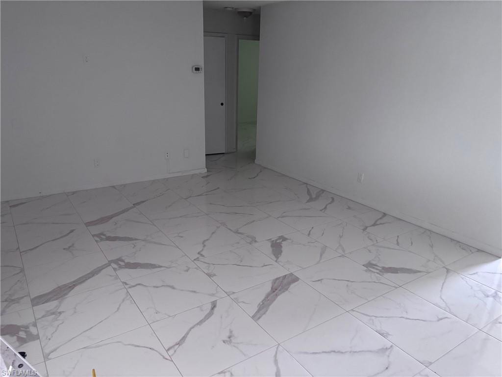 Unfurnished room featuring light marble finish flooring