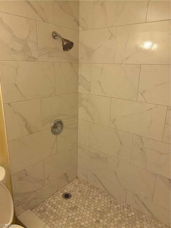 Bathroom featuring toilet and a tile shower