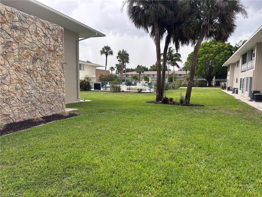 View of green lawn with central air condition unit
