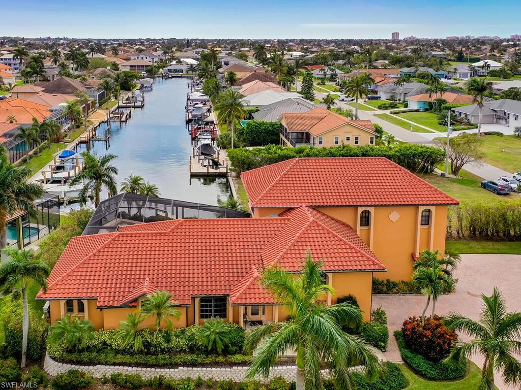 Birds eye view of property with a water view