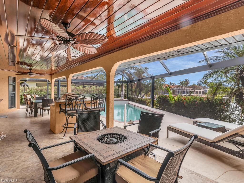 View of patio with glass enclosure and ceiling fan