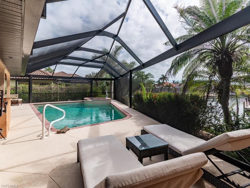 View of swimming pool featuring a patio area and a lanai