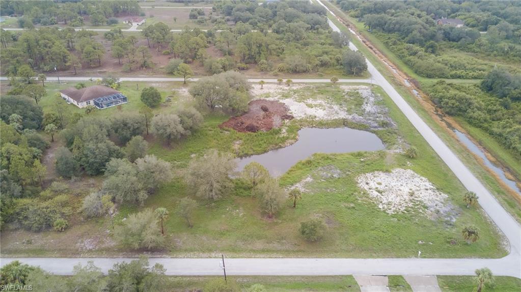 Aerial view of property and surrounding area with a large body of water