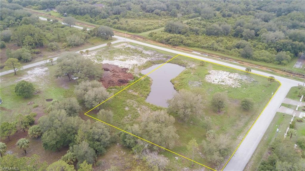 Aerial overview of property's location with property boundaries highlighted and a large body of water