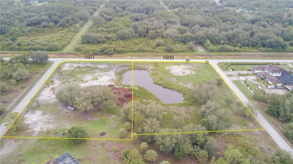 View of property location featuring a large body of water, a forest, and property boundaries highlighted