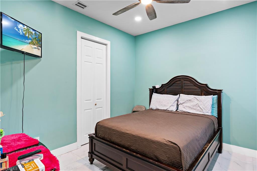 Bedroom with light marble finish floors, baseboards, ceiling fan, and recessed lighting