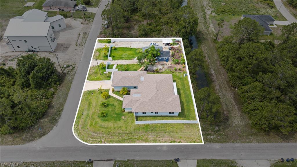 Aerial view of residential area with property boundaries highlighted