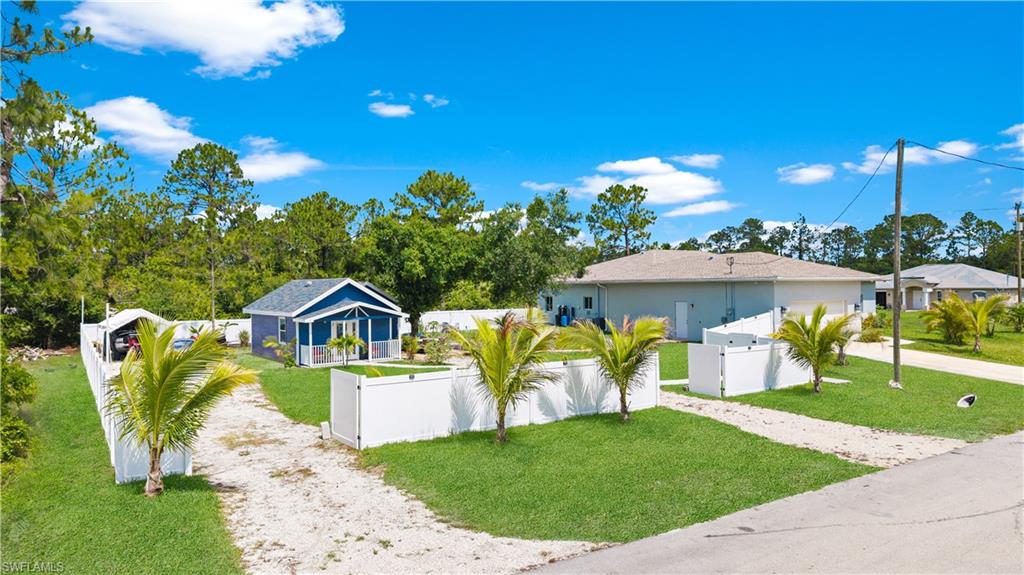 View of front of house with driveway and a gate