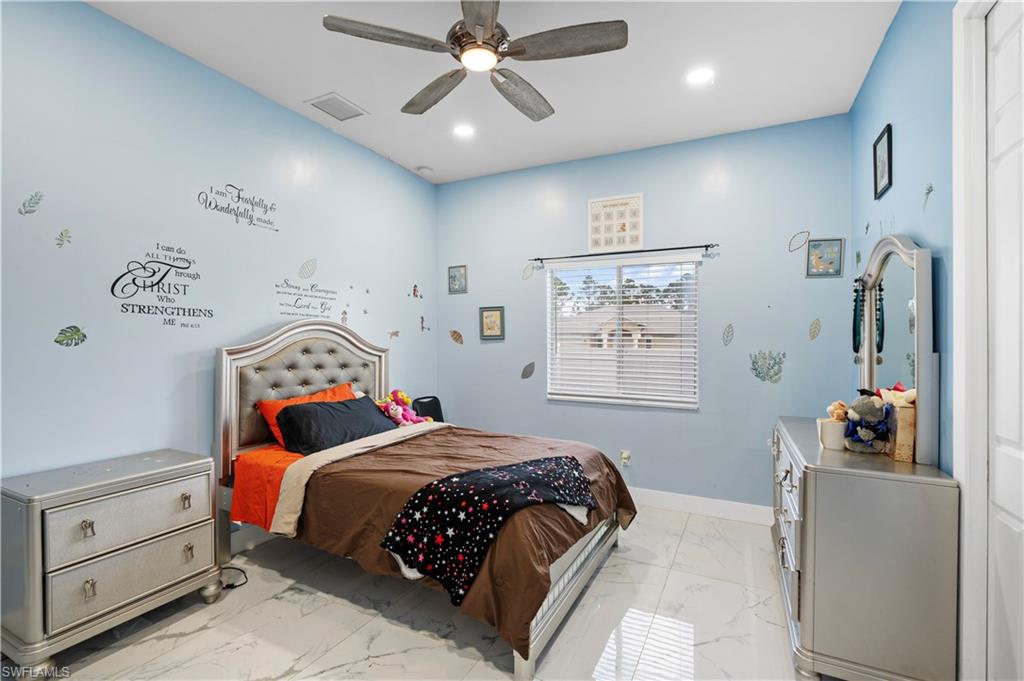 Bedroom featuring light marble finish flooring, recessed lighting, baseboards, and ceiling fan