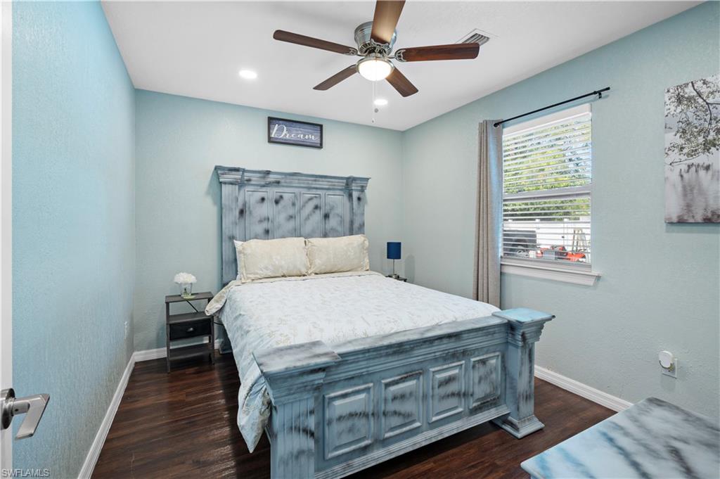 Bedroom with baseboards, dark wood-style flooring, ceiling fan, and recessed lighting