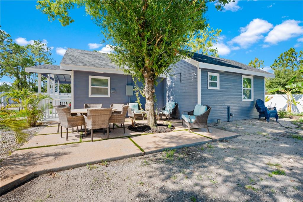 Back of house with a patio and outdoor lounge area