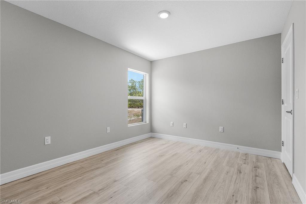 Spare room with light wood finished floors and baseboards