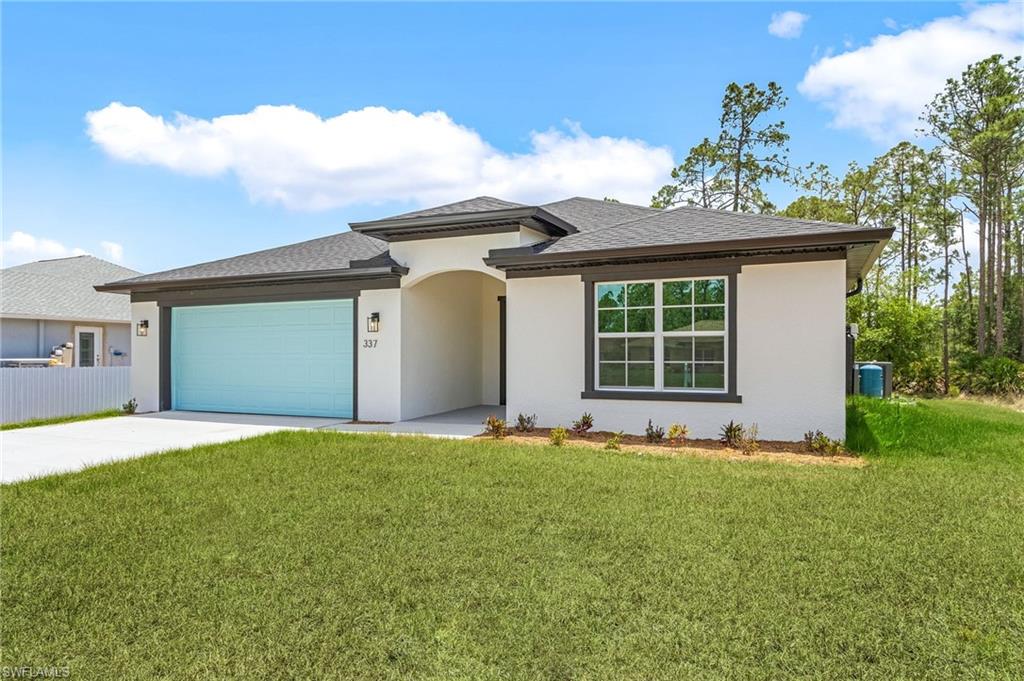 View of front of property featuring a garage, driveway, stucco siding, and roof with shingles