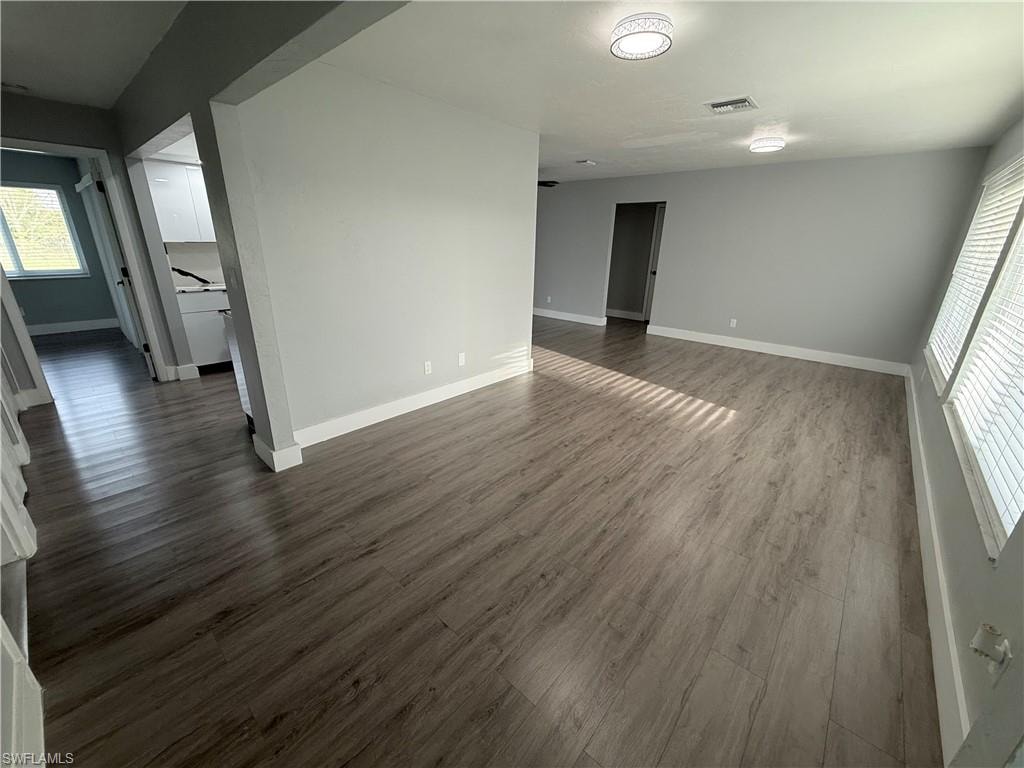 Empty room with dark wood-type flooring