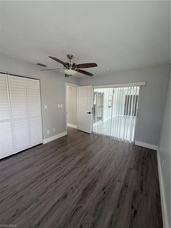 Unfurnished living room with ceiling fan and dark wood finished floors